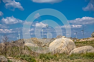 View of a wind turbines on top of mountains