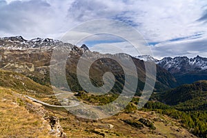 View of the winding mountain road over the Bernina pass into the Val Poschiavo in the southern Swiss Alp in late autumn