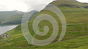 View of a winding road to Trollanes village in Kalsoy Island, Faroe Islands