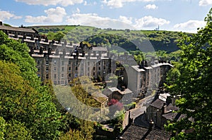 A view of the winding streets and tall stone houses in hebden bridge se in the surrounding west yorkshire countryside