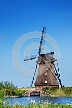 View of windmill on arrogation channel in Holland