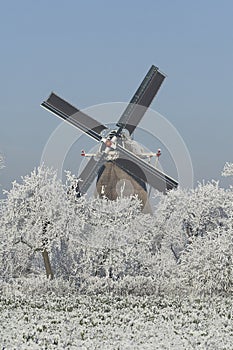 View on the windmill Bolwerksmolen near Deventer, the Netherlands, on a cold day in winter with snow and frost