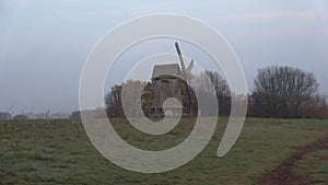 View on the windmill in a field, foggy morning. Mikhailovskoe, Pushkin Mountains