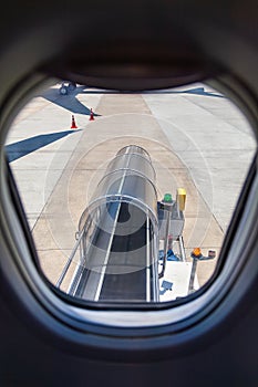 view through the window of the aircraft on the elevator for loading luggage into the aircraft