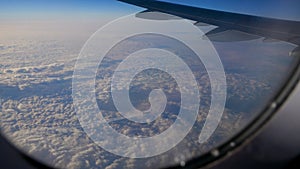 View from the window of aircraft on the wing and plane flying under them