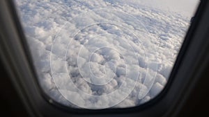 View from the window of airplane above the clouds.