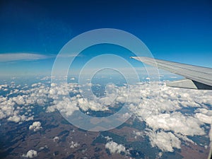 View from the window of an airplane, above the clouds