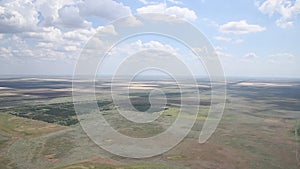 View from the window of a helicopter flying over a beautiful landscape on a bright sunny summer day