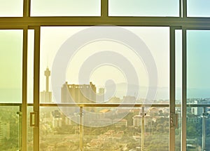 View of window and high building at sunset