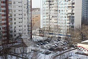 View from the window of a high-rise building into the courtyard and panel houses in winter in spring photo