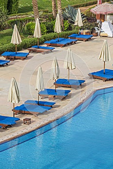 The view from the window of the hotel to the swimming pool, sun umbrellas and deck chairs in Sharm el Sheikh, Egypt