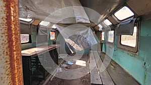 View through the window inside adandoned trailer, rusty and dirty caravan mobile home, wide angle 4k footage