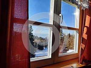 View from the window od a challet to the nature on the mountain during winter.