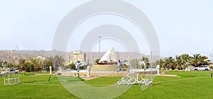View from the window of monument to the sailboat and dolphins on a roundabout in the suburbs of the Sharjah city, United Arab