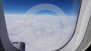 View from the window of a passenger plane flying over the clouds. Look out the window of the airliner. The concept of