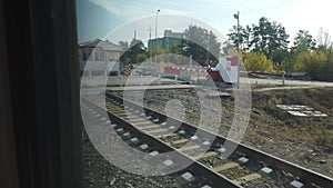 View from the window of a passenger train to the settlement, selective focus