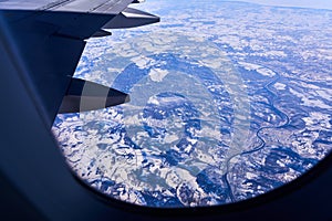 View from the window of the plane to the ground during the flight. The concept of traveling by plane