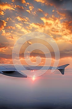 The view from the window of the plane. The wing of the plane, the sun under the wing