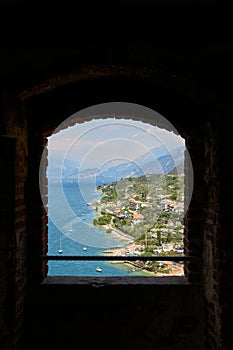 View through a window of the Scaliger Castle, Castello Scaligero on the coast of Lake Garda near Malcesine