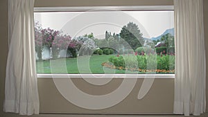 View from the window to beautiful garden with lawn, flowers and automatic sprinkler system. Background Plate, Chroma Key