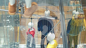 View through window to modern concept manikins at the store.