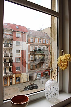 View from the window to the street with a colorful old house