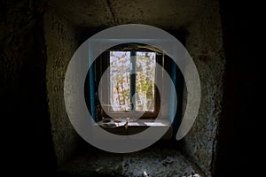 View from the window to the street, cross. Ancient Rock-cave monastery, Sataniv, Khmelnytskyi region, Ukraine. The top of the