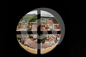 View through the window on the tower of the castle and the view of Cesky Krumlov with the famous Cesky Krumlov Castle, the Church