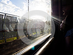 view from the window of a train, partly blurred, on a Sunny day