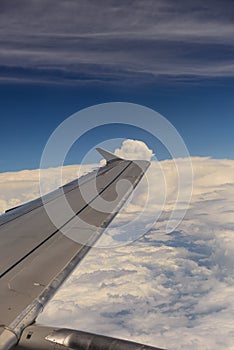 Aerial view of wing from jetplane blue sky and big white cloud background photo