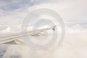 Aerial view of wing from jetplane blue sky and big white cloud background photo