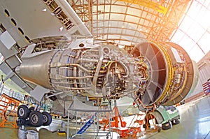 View of the wing and engine of the aircraft repair in the hangar.