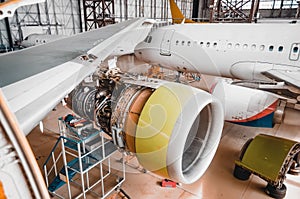 View of the wing and engine of the aircraft repair in the hangar.