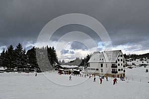 View of the winter mountain center with a ski slope