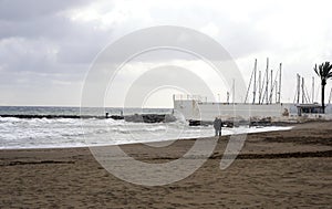 View of the winter sea. Wet sand, empty beach, cold sea, gray rain clouds. Sadness Depression.