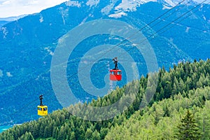 View of Wolfgangsee lake, mountains and colorful Seilbahn cable car gondolas from Zwolferhorn mountain
