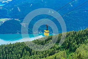 View of Wolfgangsee lake, mountains and yellow Seilbahn cable car gondola from Zwolferhorn mountain
