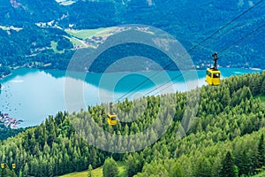 View of Wolfgangsee lake, mountains and yellow Seilbahn cable car gondolas from Zwolferhorn mountain