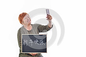 View of a woman with a blackboard with Chinese symbols that can be read as
