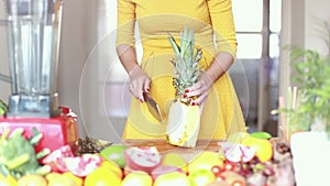 View of woman hands cutting pineapple