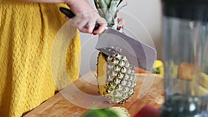 View of woman hands cutting pineapple