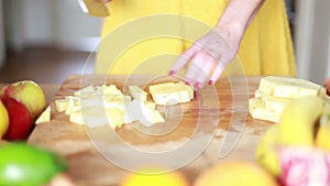 View of woman hands cutting pineapple on small pieces