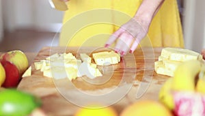 View of woman hands cutting pineapple on small pieces