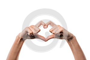 View of woman showing heart-shape sign with fingers isolated on white