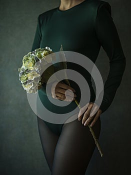 View of a woman torso holding a flower