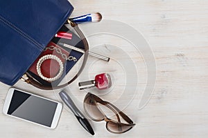 View on women bag stuff with copyspace on wooden background