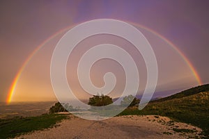 View of wonderful rainbow after the autumn storm in mountain