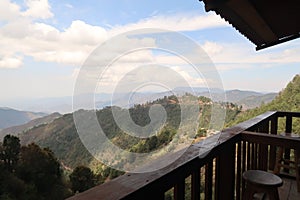 View from a wooden balcony onto the hilly landscape of San Jose del Pacifico, Oaxaca, Mexico photo