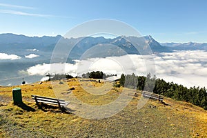 View of a wooden bench facing the beautiful panorama of Mountain Zugspitze