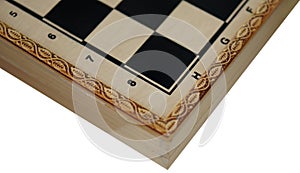 View of a wooden chess board with squares and pieces in side
